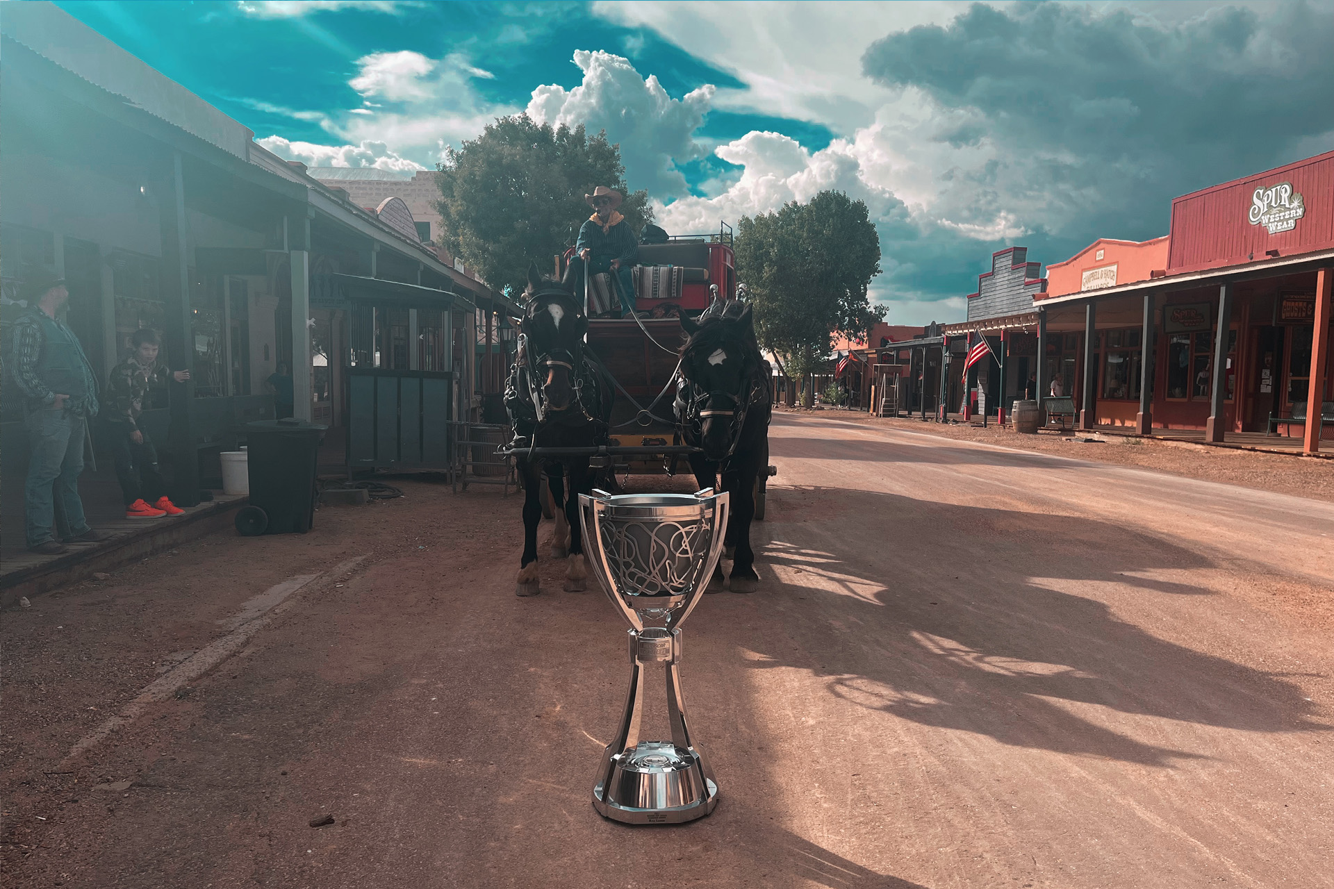 The Bill France Cup in front of a carriage with horses in the town of Tombstone